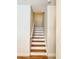 Staircase with hardwood treads and white risers at 7543 Red Mill Circle Cir, New Port Richey, FL 34653