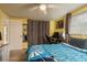 Bright bedroom with views to the bathroom, desk and bed, and yellow walls at 7901 Marlboro Dr, Port Richey, FL 34668