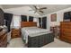 Cozy bedroom featuring a large bed, ceiling fan, and stylish furnishings at 7901 Marlboro Dr, Port Richey, FL 34668