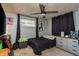 Cozy bedroom featuring a ceiling fan, and complemented by decor, creating a comfortable personal space at 7901 Marlboro Dr, Port Richey, FL 34668