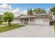 Charming single-story home featuring a well-maintained lawn, a two car garage and solar panels on the roof at 7901 Marlboro Dr, Port Richey, FL 34668