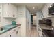 Bright and airy kitchen with white cabinets, providing a clean and inviting space for meal preparation at 7901 Marlboro Dr, Port Richey, FL 34668