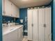 Functional laundry room with a washer, dryer, storage cabinets, and ample space for laundry tasks at 7901 Marlboro Dr, Port Richey, FL 34668