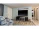 Comfortable living room with an entertainment system, neutral walls, and hardwood floors at 7901 Marlboro Dr, Port Richey, FL 34668