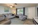 Comfortable living room with neutral walls, hardwood floors, and ample natural light from a large window at 7901 Marlboro Dr, Port Richey, FL 34668