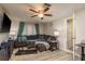 Inviting living room with a comfortable couch, ceiling fan, and an adjacent bathroom at 7901 Marlboro Dr, Port Richey, FL 34668