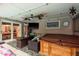 Inviting screened-in patio with seating, TV, refrigerator, and jacuzzi, creating an ideal space for outdoor relaxation at 7901 Marlboro Dr, Port Richey, FL 34668