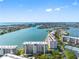 Stunning aerial view of a waterfront community with beautiful coastal scenery and luxurious condo buildings at 7932 Sailboat Key S Blvd # 406, South Pasadena, FL 33707