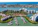 Aerial view of waterfront condos, marina, tennis courts, and bay with city views at 7932 Sailboat Key S Blvd # 406, South Pasadena, FL 33707