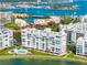 This aerial shot shows several waterfront condominiums with stunning bay views and a community pool at 7932 Sailboat Key S Blvd # 406, South Pasadena, FL 33707