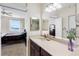 This bathroom features a sink and a view of the bedroom with water views at 7932 Sailboat Key S Blvd # 406, South Pasadena, FL 33707