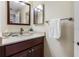 Close-up of bathroom vanity with solid surface counter, modern faucet, mirror and decor at 7932 Sailboat Key S Blvd # 406, South Pasadena, FL 33707