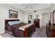 This bedroom features warm tones, a ceiling fan, and a view into the bathroom at 7932 Sailboat Key S Blvd # 406, South Pasadena, FL 33707