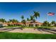 The clubhouse features lush landscaping, an American flag, and a brick driveway at 7932 Sailboat Key S Blvd # 406, South Pasadena, FL 33707