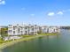 Stunning waterfront condo complex with a community pool, manicured lawns, and serene water views at 7932 Sailboat Key S Blvd # 406, South Pasadena, FL 33707
