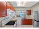 Updated kitchen with cherry cabinets, white appliances, and an open concept design overlooking the living area at 7932 Sailboat Key S Blvd # 406, South Pasadena, FL 33707