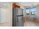 Bright kitchen nook with a stainless-steel refrigerator and a cozy breakfast area with a view at 7932 Sailboat Key S Blvd # 406, South Pasadena, FL 33707