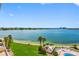Scenic water view from the condo, with lush greenery, a pool, and the sparkling bay at 7932 Sailboat Key S Blvd # 406, South Pasadena, FL 33707