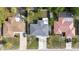 Aerial view of the property showcasing the roof, driveway, and surrounding landscaping at 8030 Jasmine Blvd, Port Richey, FL 34668