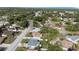 Aerial view of the home in a lush neighborhood with nearby streets and community features at 8030 Jasmine Blvd, Port Richey, FL 34668