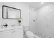 A newly renovated bathroom featuring modern fixtures, new tile, and a shower at 8030 Jasmine Blvd, Port Richey, FL 34668