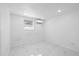 Clean bedroom with a window and mini split air conditioning unit at 8030 Jasmine Blvd, Port Richey, FL 34668