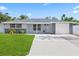 Charming single-story home featuring a well-manicured lawn and attached garage at 8030 Jasmine Blvd, Port Richey, FL 34668