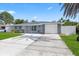 This home features a tidy front lawn, one car garage, and freshly painted exterior at 8030 Jasmine Blvd, Port Richey, FL 34668