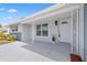 Inviting front porch with decorative metal posts and a freshly painted front door at 8030 Jasmine Blvd, Port Richey, FL 34668