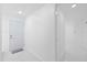 Clean and bright hallway with white walls and tile flooring at 8030 Jasmine Blvd, Port Richey, FL 34668