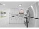 Well-equipped kitchen with stainless steel appliances, white cabinets, and a window view at 8030 Jasmine Blvd, Port Richey, FL 34668