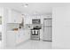 Modern kitchen features stainless steel appliances, white cabinets, and quartz countertops at 8030 Jasmine Blvd, Port Richey, FL 34668