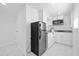 Compact kitchenette featuring modern appliances and granite countertops at 8030 Jasmine Blvd, Port Richey, FL 34668