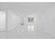 Bright, spacious living room with modern tile flooring and plenty of natural light at 8030 Jasmine Blvd, Port Richey, FL 34668