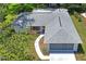 Aerial view of single-story home, showcasing roof, landscaping, and attached garage at 8405 Divot Way, Port Richey, FL 34668
