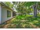 Spacious, lush backyard featuring mature trees, perfect for outdoor activities and relaxation at 8405 Divot Way, Port Richey, FL 34668