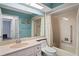 Bathroom features a vanity sink, a large mirror, and a bathtub and shower combination at 8405 Divot Way, Port Richey, FL 34668