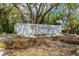 Timber Oaks community entrance sign surrounded by mature trees and lush landscaping at 8405 Divot Way, Port Richey, FL 34668
