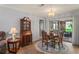Dining room featuring a decorative rug and access to a sunroom with outdoor views at 8405 Divot Way, Port Richey, FL 34668