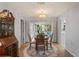 Bright dining area featuring a chandelier and views of the lanai, perfect for casual or formal dining at 8405 Divot Way, Port Richey, FL 34668