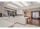 Bright kitchen featuring white cabinets, countertops, and tile flooring with backyard view at 8405 Divot Way, Port Richey, FL 34668