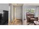 Bright living room featuring a front door, side windows, and comfortable seating at 8405 Divot Way, Port Richey, FL 34668