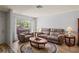Cozy living room with neutral tones, hardwood floors, and ample natural light at 8405 Divot Way, Port Richey, FL 34668
