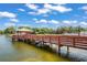 Scenic view of a wooden pier extending into a tranquil lake, complemented by a gazebo at 8405 Divot Way, Port Richey, FL 34668
