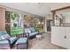 Inviting sunroom with tiled floors, ceiling fans, and comfortable wicker furniture with outdoor views at 8405 Divot Way, Port Richey, FL 34668