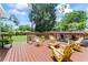 Inviting backyard deck with seating, potted plants and view of the expansive backyard at 9000 Bay Ne St, St Petersburg, FL 33702