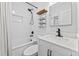 Bright bathroom featuring a tub with white tile surround and a vanity with a marble countertop at 9000 Bay Ne St, St Petersburg, FL 33702
