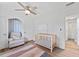 Bright bedroom featuring hardwood floors, ceiling fan, and neutral paint, with large windows allowing ample natural light at 9000 Bay Ne St, St Petersburg, FL 33702