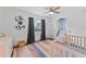 Bright bedroom featuring hardwood floors, ceiling fan, and neutral paint, with large windows allowing ample natural light at 9000 Bay Ne St, St Petersburg, FL 33702