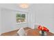 Dining area boasting wood floors, a round table with chairs, and a view from the window at 9000 Bay Ne St, St Petersburg, FL 33702